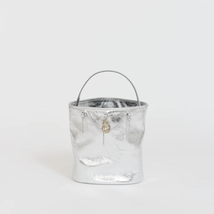 Marge Sherwood Wired Bucket Bag in crinkled metallic silver leather with a slim top handle and gold-tone charm on chain