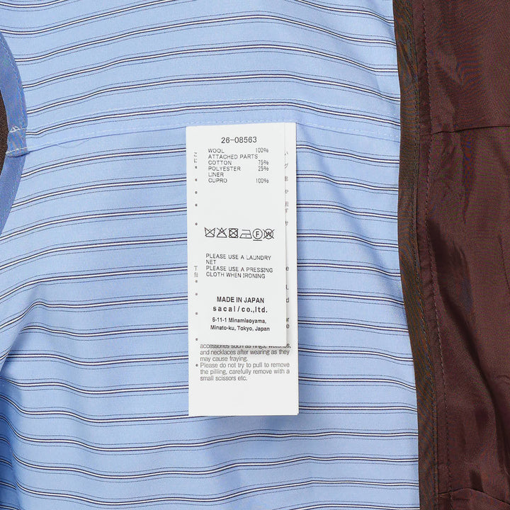 sacai Suiting x Poplin Jacket in brown — a cropped double-breasted blazer with ornate gold buttons layered over a blue striped poplin shirt, shown on a display form against a white background