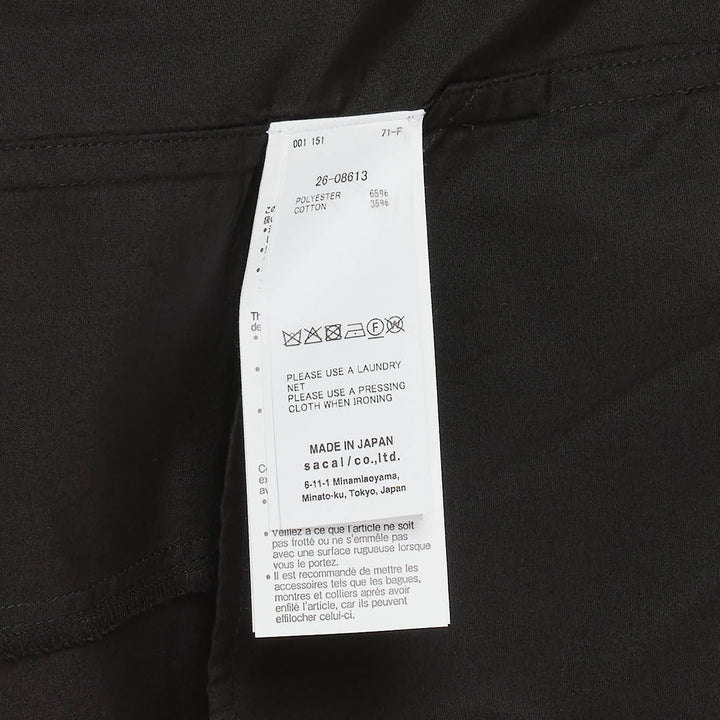 sacai black cotton poplin short-sleeve shirt dress with oversized bow waist detail and voluminous pleated skirt, front view on white background