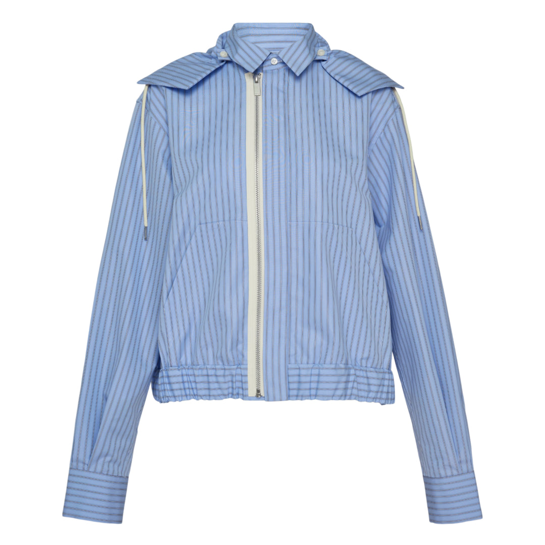 sacai black poplin zip-up jacket with layered sleeve detailing, silver zipper, spread collar with snap tabs, and ribbed hem, front view on white background