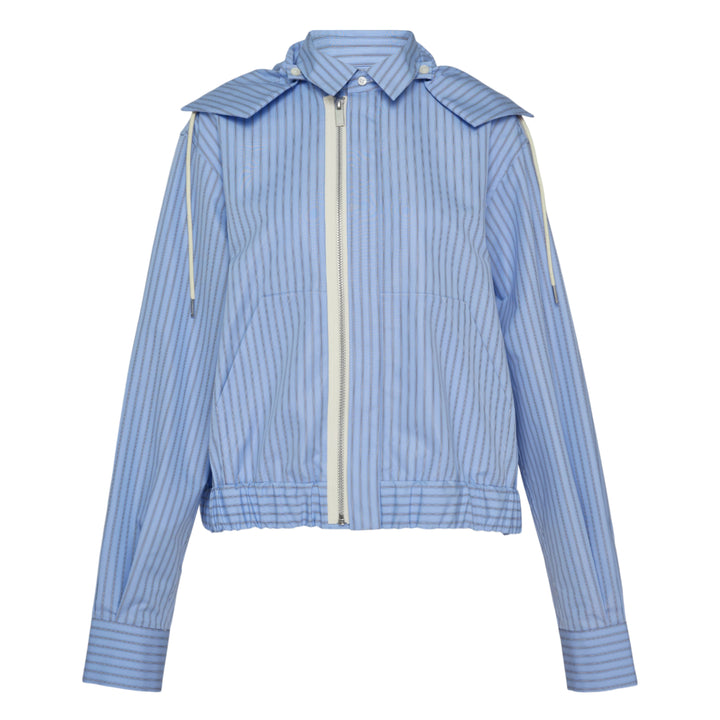 sacai black poplin zip-up jacket with layered sleeve detailing, silver zipper, spread collar with snap tabs, and ribbed hem, front view on white background