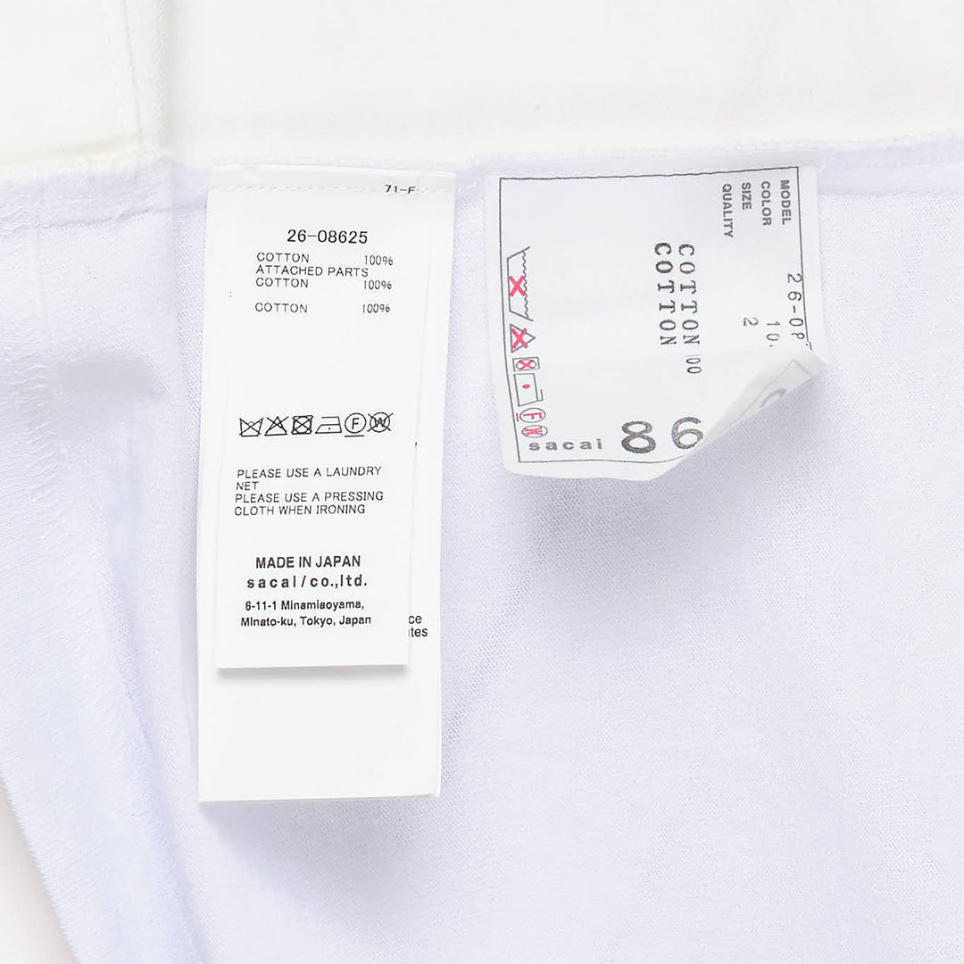 sacai Denim x Cotton Jersey T-Shirt in black and indigo, featuring panelled denim sides, a flared hem, ribbed crew neck, and a patch chest pocket