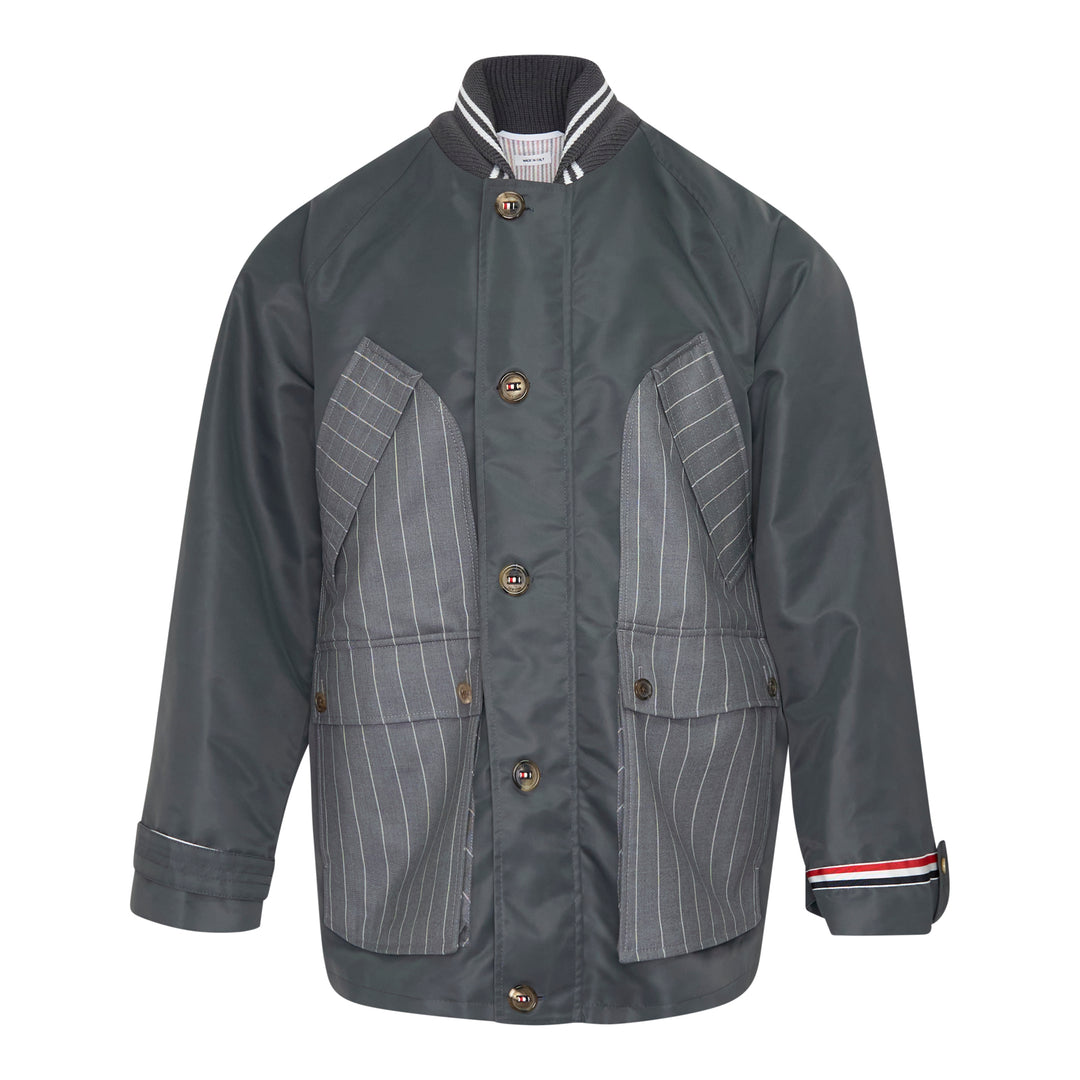 Back view of Thom Browne Cropped Field Jacket in slate grey with ribbed collar, signature red, white, and blue grosgrain trim at collar label, rear pocket tabs, and cuffs
