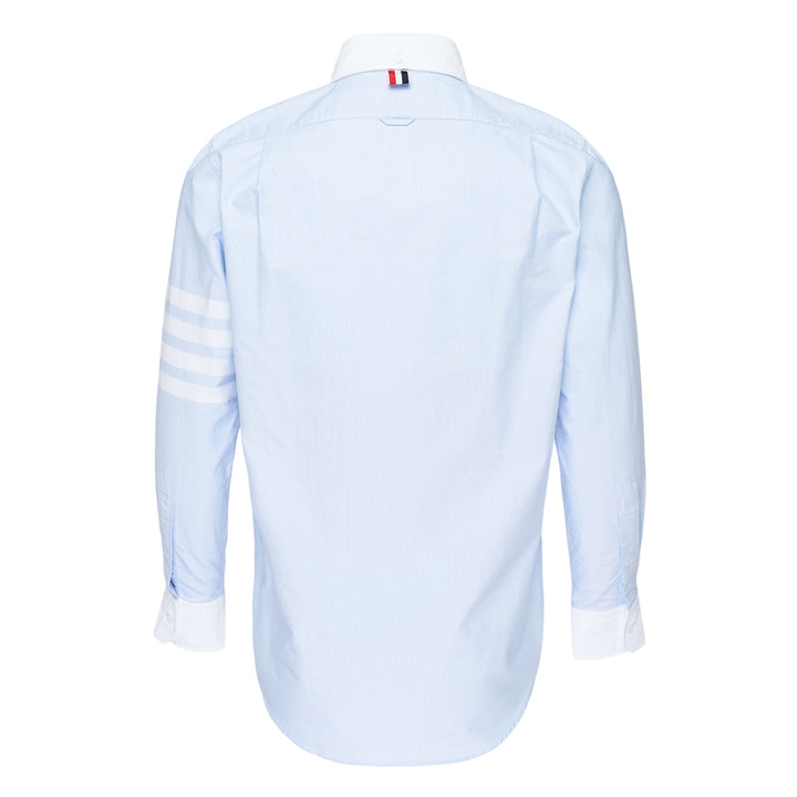 Thom Browne straight fit light blue Oxford long sleeve shirt with contrast white button-down collar, double cuffs, four-bar stripe on sleeve, and chest patch pocket