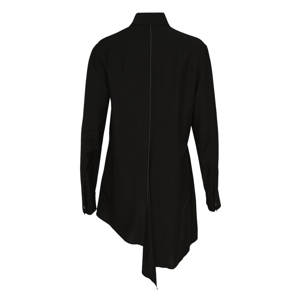 Yohji Yamamoto black paneled long shirt with asymmetric draped hem, contrast stitching, point collar, and button-front placket, displayed on a hanger against a white background