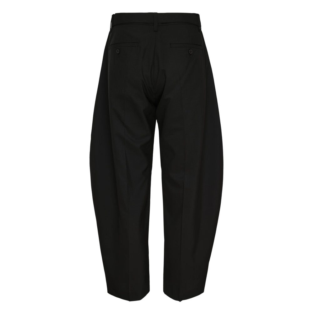 sacai Belted Suiting Pants in black, featuring a sculptural barrel-leg silhouette, front pleating, and an integrated self-fabric belt with a gunmetal-tone buckle