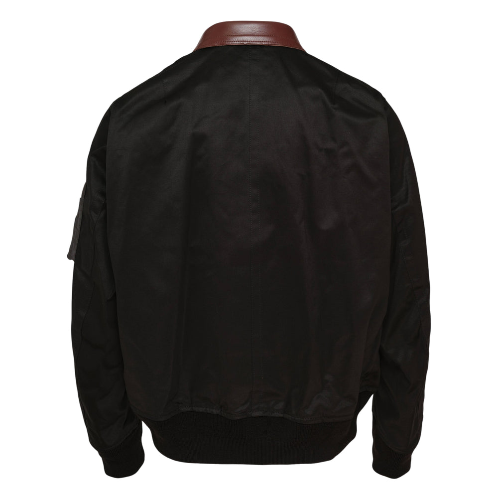 sacai Cotton Chino Blouson in black with burgundy leather collar, silver two-way zip, multiple front pockets, and sleeve zip pocket, displayed flat on white background