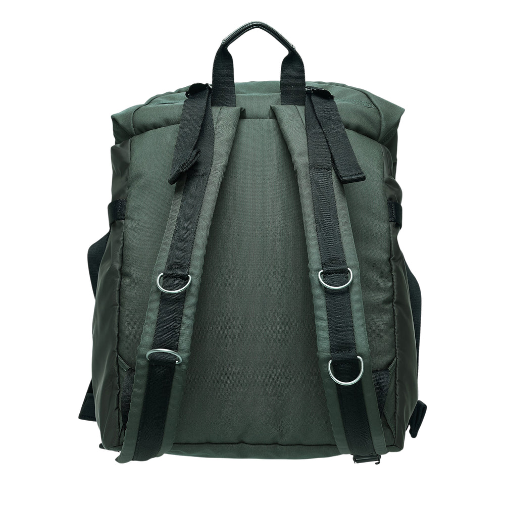 sacai Utility Backpack in olive green nylon with dual-tone front panel, quilted snap pocket, zipper pocket, top carry handle, and adjustable shoulder straps