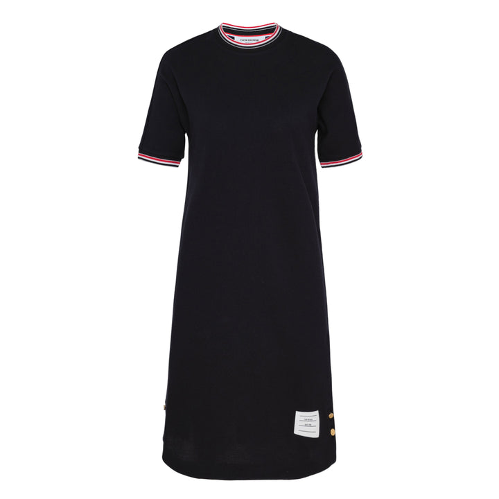 Thom Browne navy cotton T-shirt dress with red, white, and blue striped tipping at the crew neck and sleeve cuffs, gold-toned button hardware at the hem, and woven brand label at the front