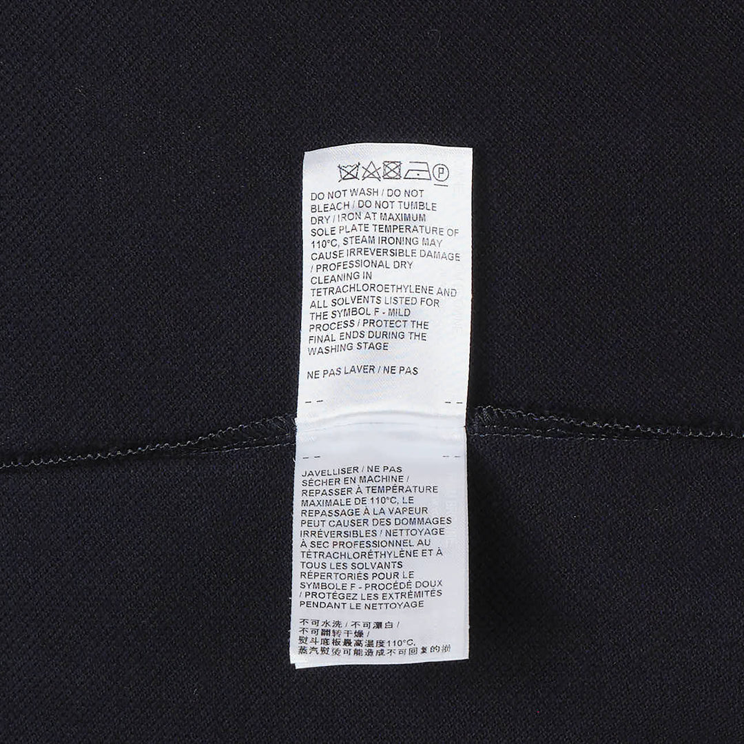Thom Browne navy cotton T-shirt dress with red, white, and blue striped tipping at the crew neck and sleeve cuffs, gold-toned button hardware at the hem, and woven brand label at the front