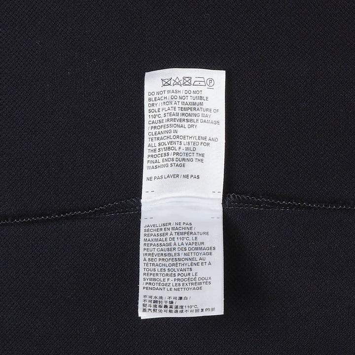 Thom Browne navy cotton T-shirt dress with red, white, and blue striped tipping at the crew neck and sleeve cuffs, gold-toned button hardware at the hem, and woven brand label at the front