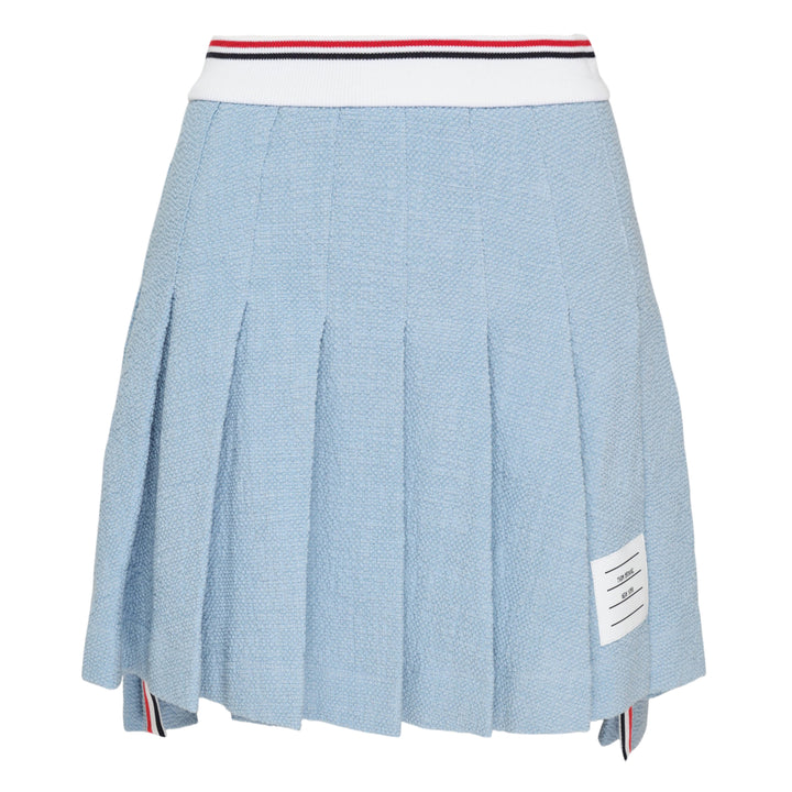 Thom Browne light blue piqué pleated mini skirt with red, white, and blue tipped ribbed waistband, full box pleats, grosgrain stripe tab at hem, and woven logo label