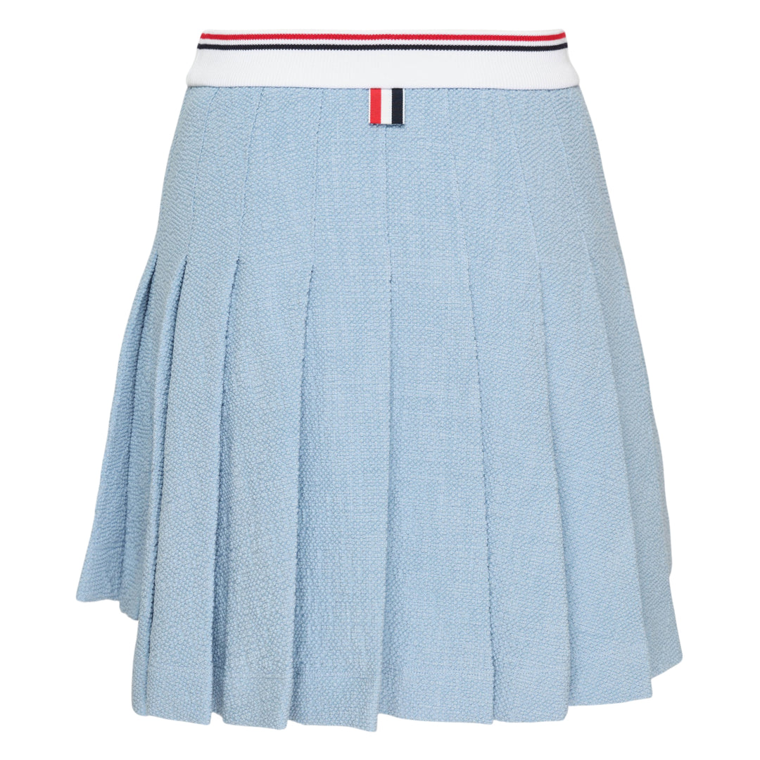 Thom Browne light blue piqué pleated mini skirt with red, white, and blue tipped ribbed waistband, full box pleats, grosgrain stripe tab at hem, and woven logo label
