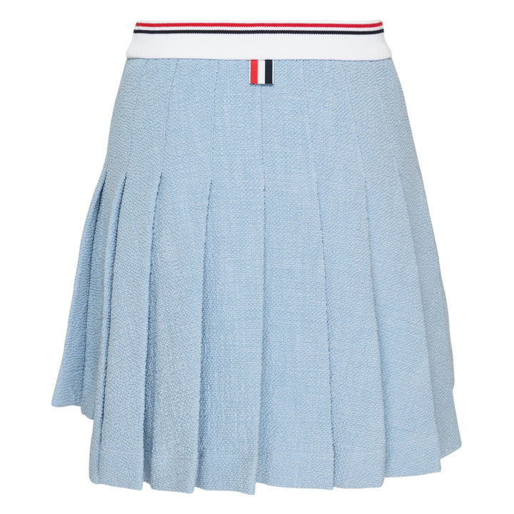 Thom Browne light blue piqué pleated mini skirt with red, white, and blue tipped ribbed waistband, full box pleats, grosgrain stripe tab at hem, and woven logo label
