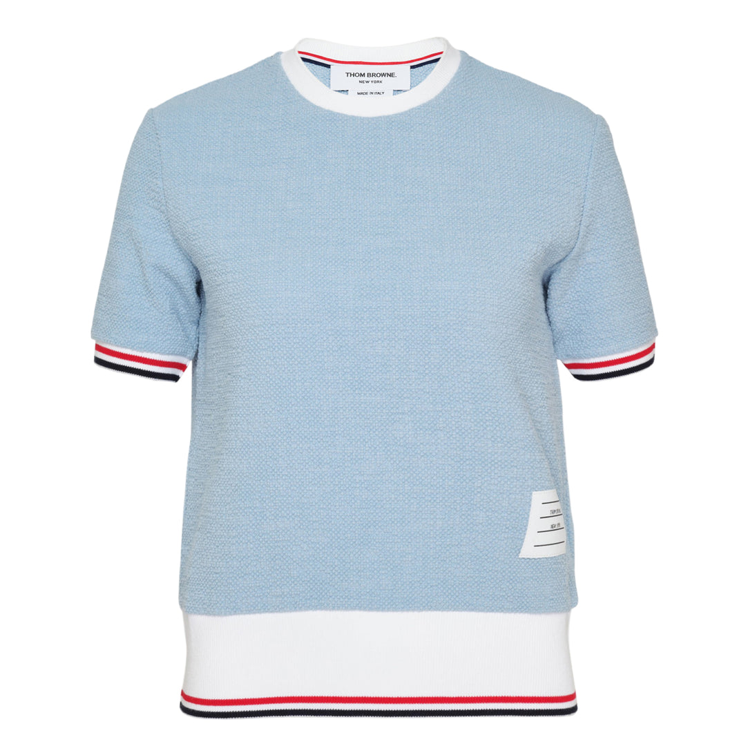 Thom Browne light blue textured knit short sleeve tee with white ribbed collar and hem, and signature red, white, and blue striped tipping on the cuffs and hem edge