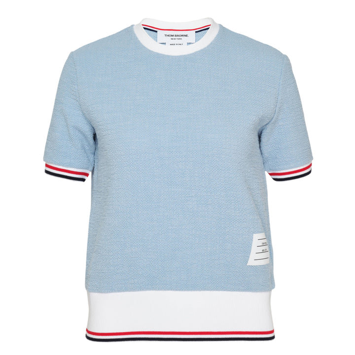 Thom Browne light blue textured knit short sleeve tee with white ribbed collar and hem, and signature red, white, and blue striped tipping on the cuffs and hem edge