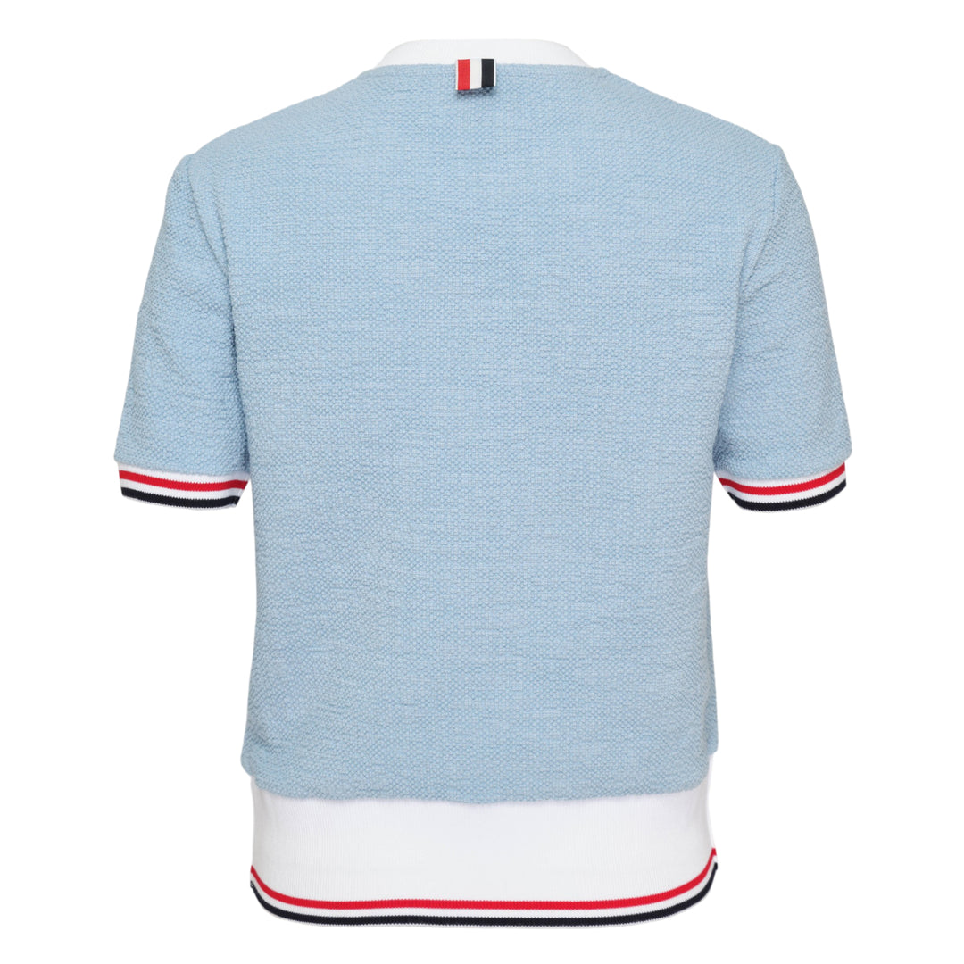 Thom Browne light blue textured knit short sleeve tee with white ribbed collar and hem, and signature red, white, and blue striped tipping on the cuffs and hem edge