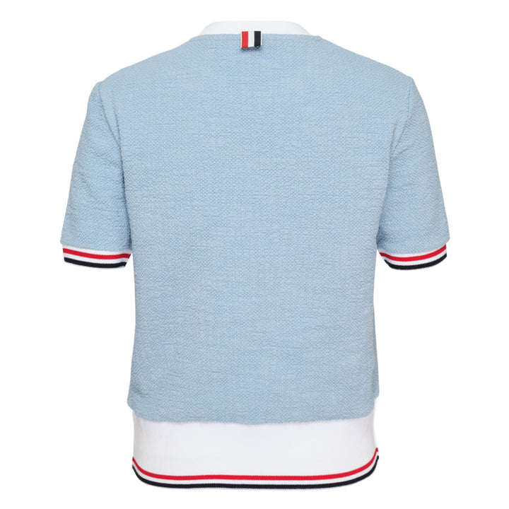 Thom Browne light blue textured knit short sleeve tee with white ribbed collar and hem, and signature red, white, and blue striped tipping on the cuffs and hem edge