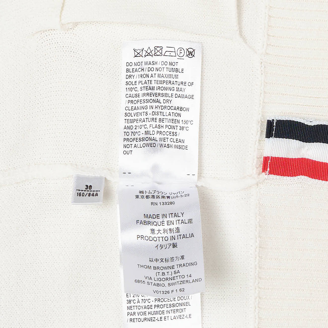 Thom Browne Sailboat Jacquard V-Neck Cardigan in navy with white contrast tipping, red, white, and blue sleeve stripe, and four-button front fastening