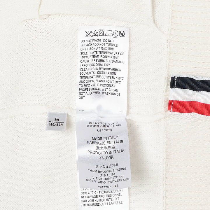 Thom Browne Sailboat Jacquard V-Neck Cardigan in navy with white contrast tipping, red, white, and blue sleeve stripe, and four-button front fastening