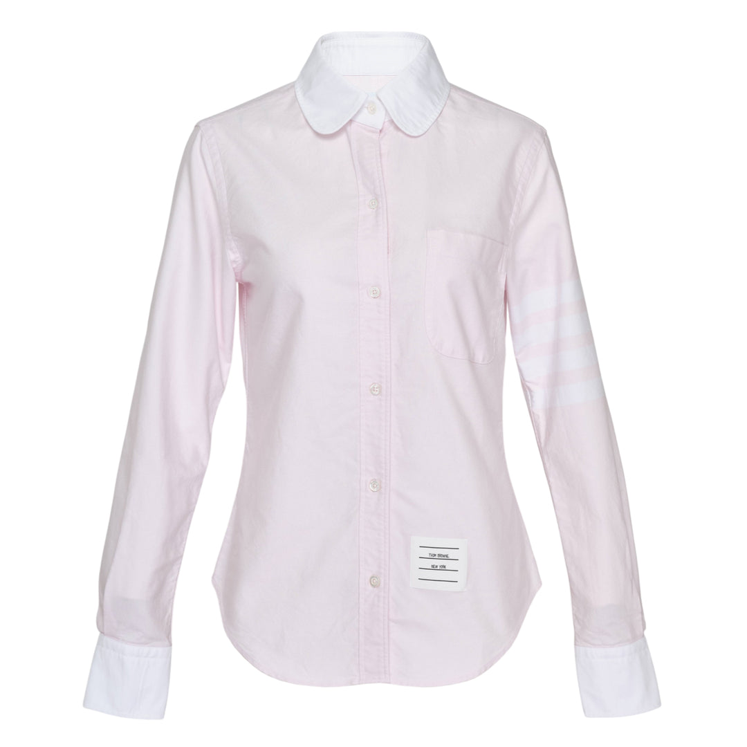 Thom Browne pale blue long sleeve blouse with round white collar, contrast white cuffs, chest pocket, and four-bar white stripe detail on the sleeve