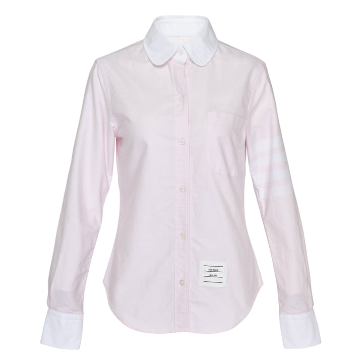 Thom Browne pale blue long sleeve blouse with round white collar, contrast white cuffs, chest pocket, and four-bar white stripe detail on the sleeve