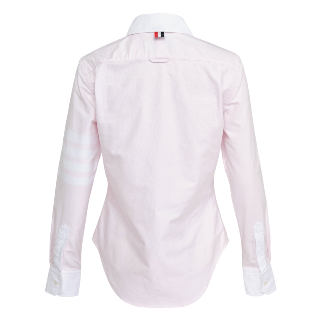 Thom Browne pale blue long sleeve blouse with round white collar, contrast white cuffs, chest pocket, and four-bar white stripe detail on the sleeve