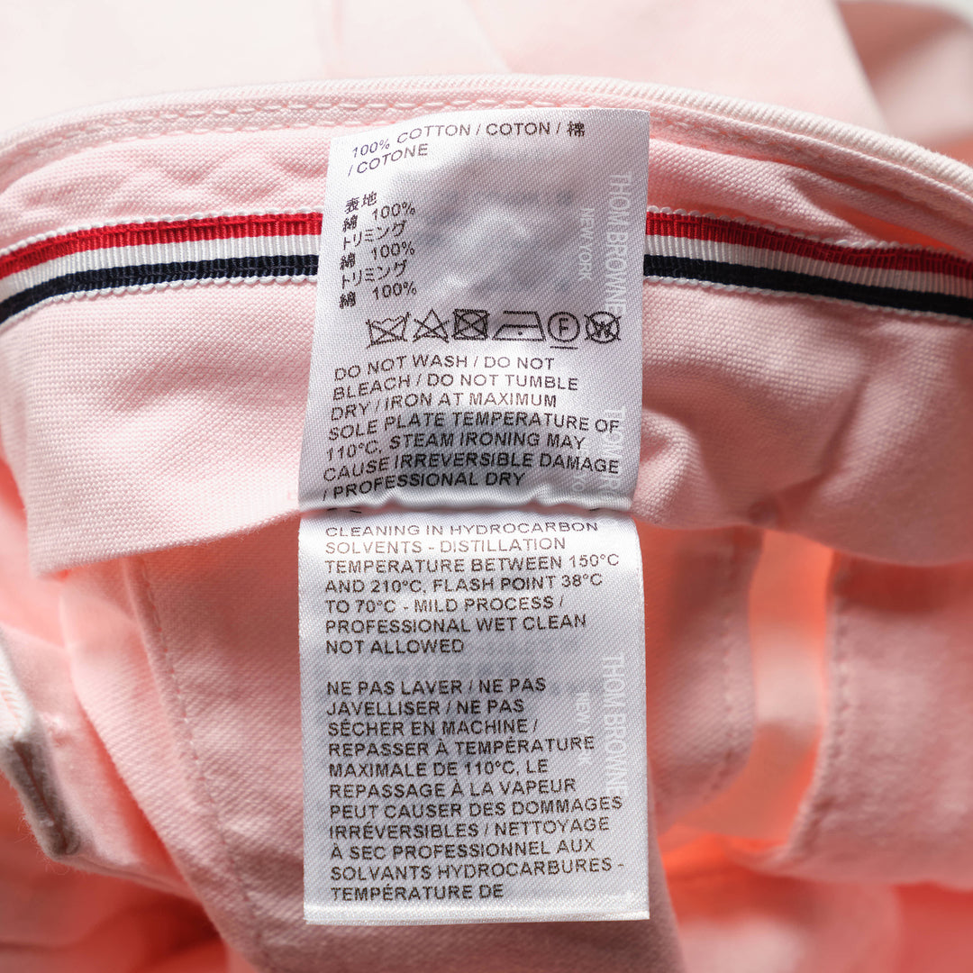 Thom Browne Beltloop Chino Pants in blush pink cotton twill, featuring a straight-leg silhouette with front creases, belt loop waistband, and cuffed hems