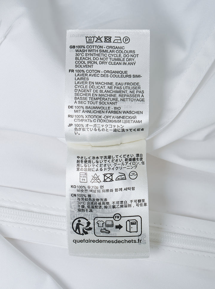 Toteme Sculptural Cotton Top in white, featuring a fitted seamed bodice, round neckline, and short fluted sleeves with a folded hem detail, shown from the front against a white background - view 3