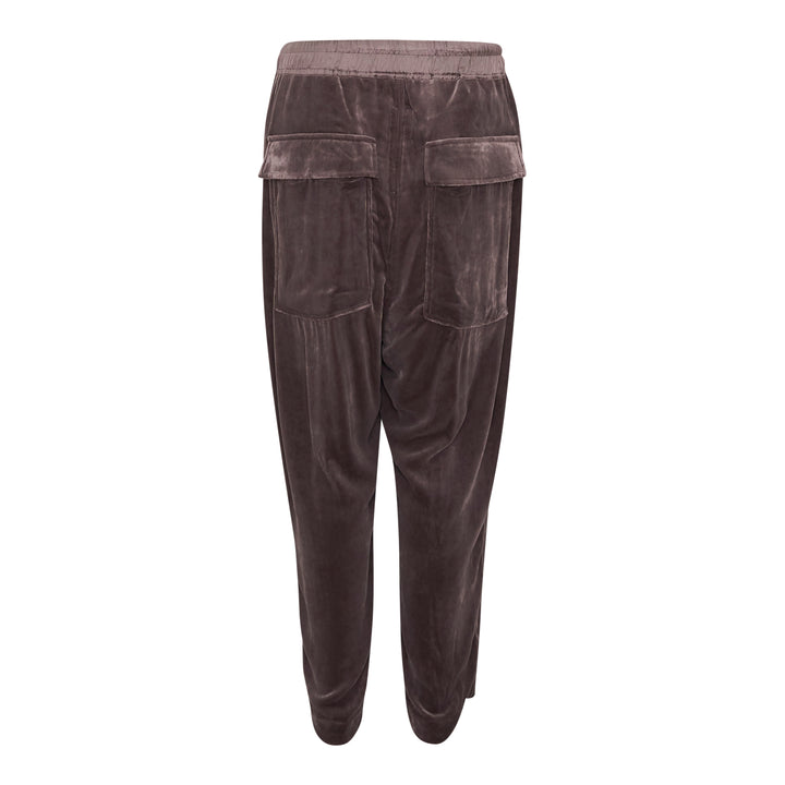 Rick Owens Drawstring Astaires Cropped Pants in black, displayed flat, featuring a dropped-crotch silhouette, pressed front crease, elasticated waistband with contrast ivory drawstring, and tapered cropped hem.