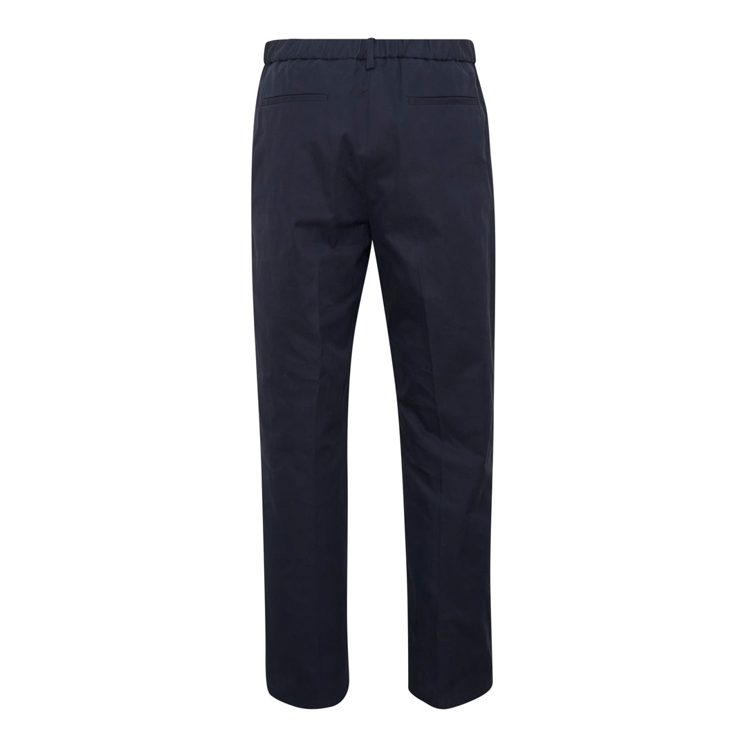 Jil Sander light brushed wool trousers in navy, featuring a high-rise waistband, pressed front creases, and a tapered straight-leg silhouette