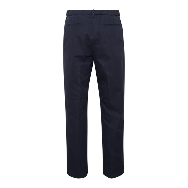 Jil Sander light brushed wool trousers in navy, featuring a high-rise waistband, pressed front creases, and a tapered straight-leg silhouette