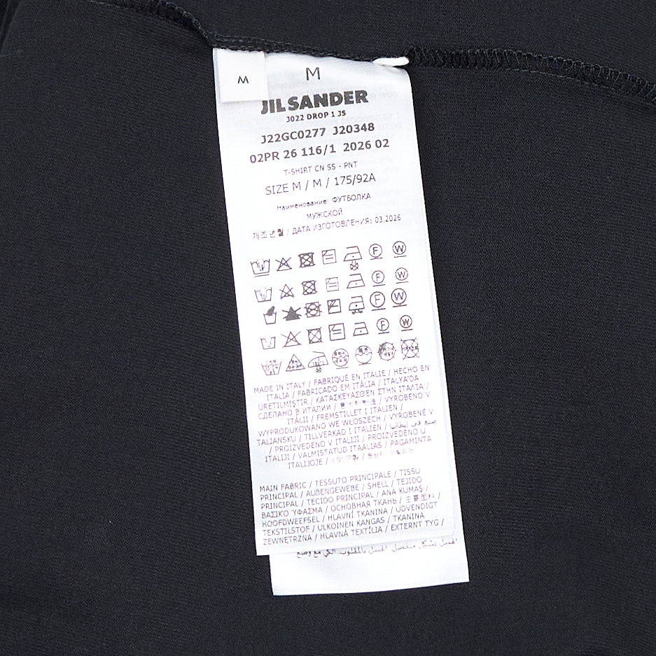 Jil Sander white oversized plain cotton short sleeve tee with vertical logo print at the hem and woven label at the neckline