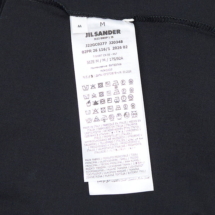 Jil Sander white oversized plain cotton short sleeve tee with vertical logo print at the hem and woven label at the neckline