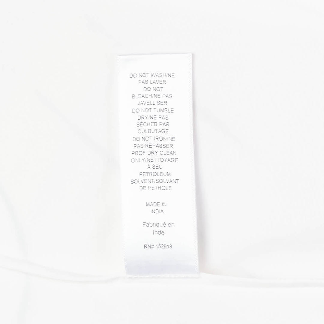 Carolina Herrera Clara Shirt in white cotton with voluminous bishop sleeves, point collar, and pearlescent button-front placket, displayed flat on a white background