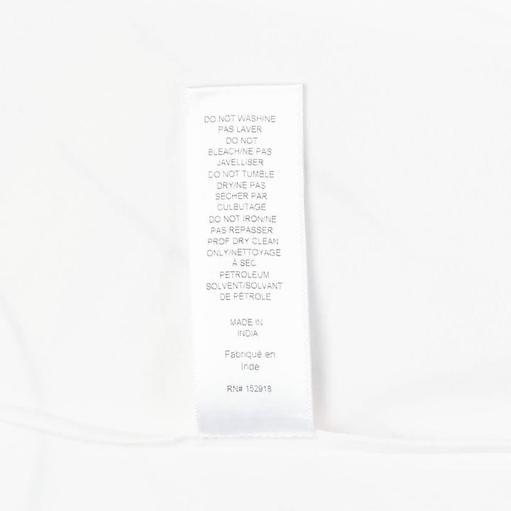 Carolina Herrera Clara Shirt in white cotton with voluminous bishop sleeves, point collar, and pearlescent button-front placket, displayed flat on a white background