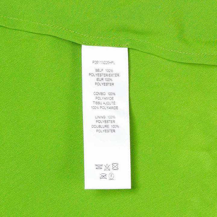Carolina Herrera bright green floral guipure lace belted crew neck top with cap sleeves, sheer yoke, coordinating slim belt, and scalloped hem, displayed on a white background