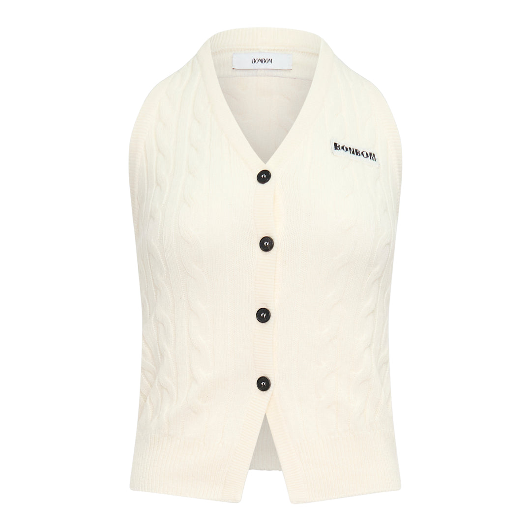 Bonbom cream cable knit cardigan vest with V-neckline, dark button fastening, and woven logo patch detail