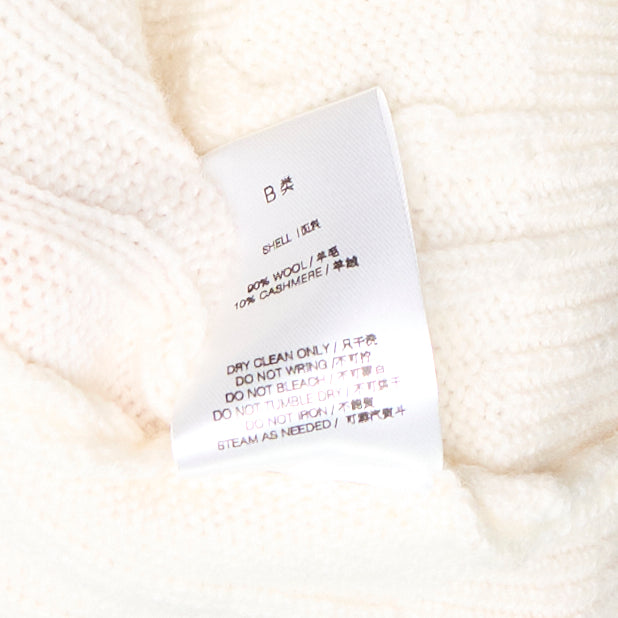 Bonbom cream cable knit cardigan vest with V-neckline, dark button fastening, and woven logo patch detail