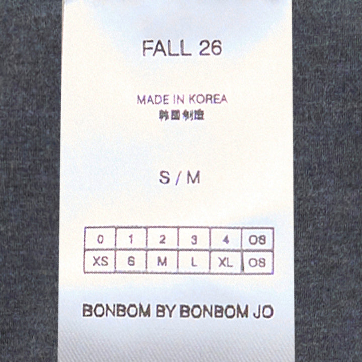 Back view of Bonbom Shoulder-Tuck Sleeveless Sweat in heathered charcoal grey, showing structured shoulder tuck detail and embroidered logo at the hem