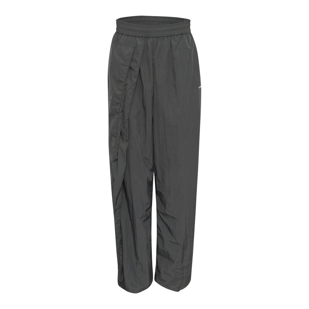 Bonbom Two-Tuck Track Pants in dark grey crinkle nylon, featuring a wide-leg silhouette, elasticated waistband, and sculptural front tuck detailing