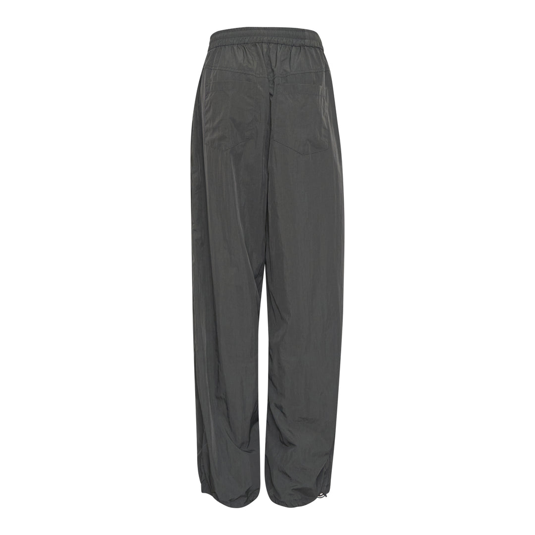 Bonbom Two-Tuck Track Pants in dark grey crinkle nylon, featuring a wide-leg silhouette, elasticated waistband, and sculptural front tuck detailing