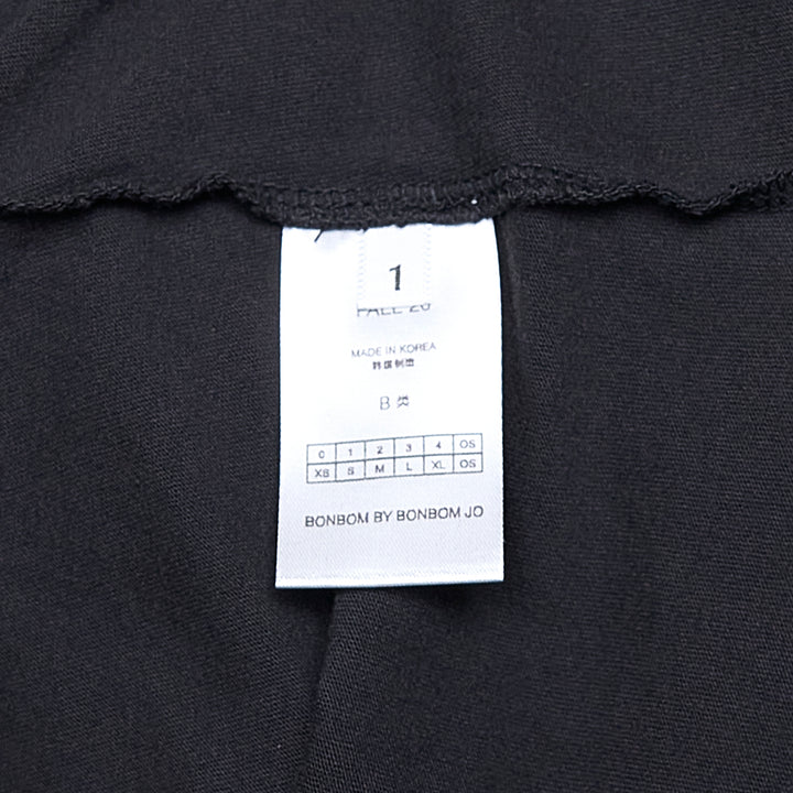 Bonbom Oval Washed Griffin Graphic Tee in vintage-washed black, featuring a gothic-lettered Bonbom logo and heraldic griffin crest oval print on the chest, relaxed crew-neck silhouette