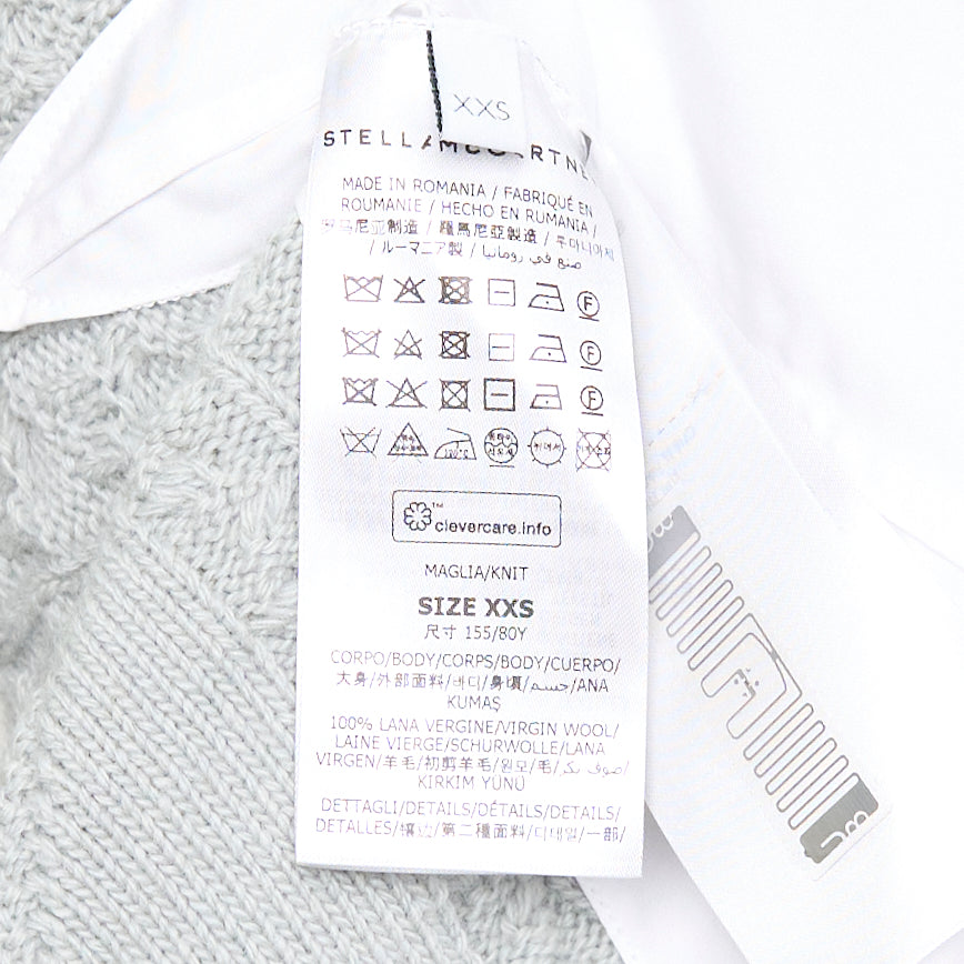 Stella McCartney Cable Knit Shirting Dress in sage green with diamond and honeycomb cable stitch sweater top layered over a white poplin shirt dress with buttoned placket
