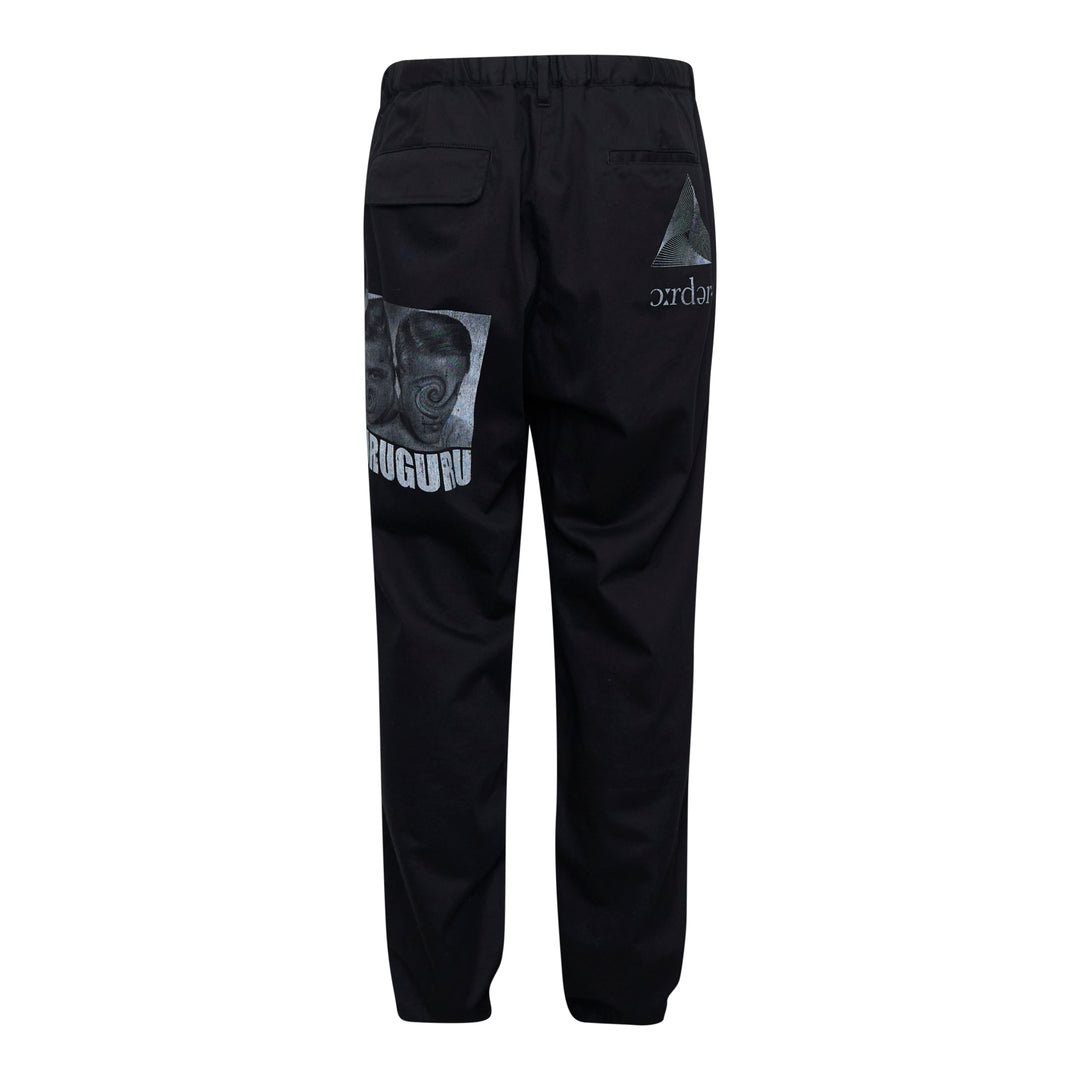 Undercover Elastic Waist Pants in black, featuring an elasticated waistband, front pleat, and tapered leg — front view on a flat lay