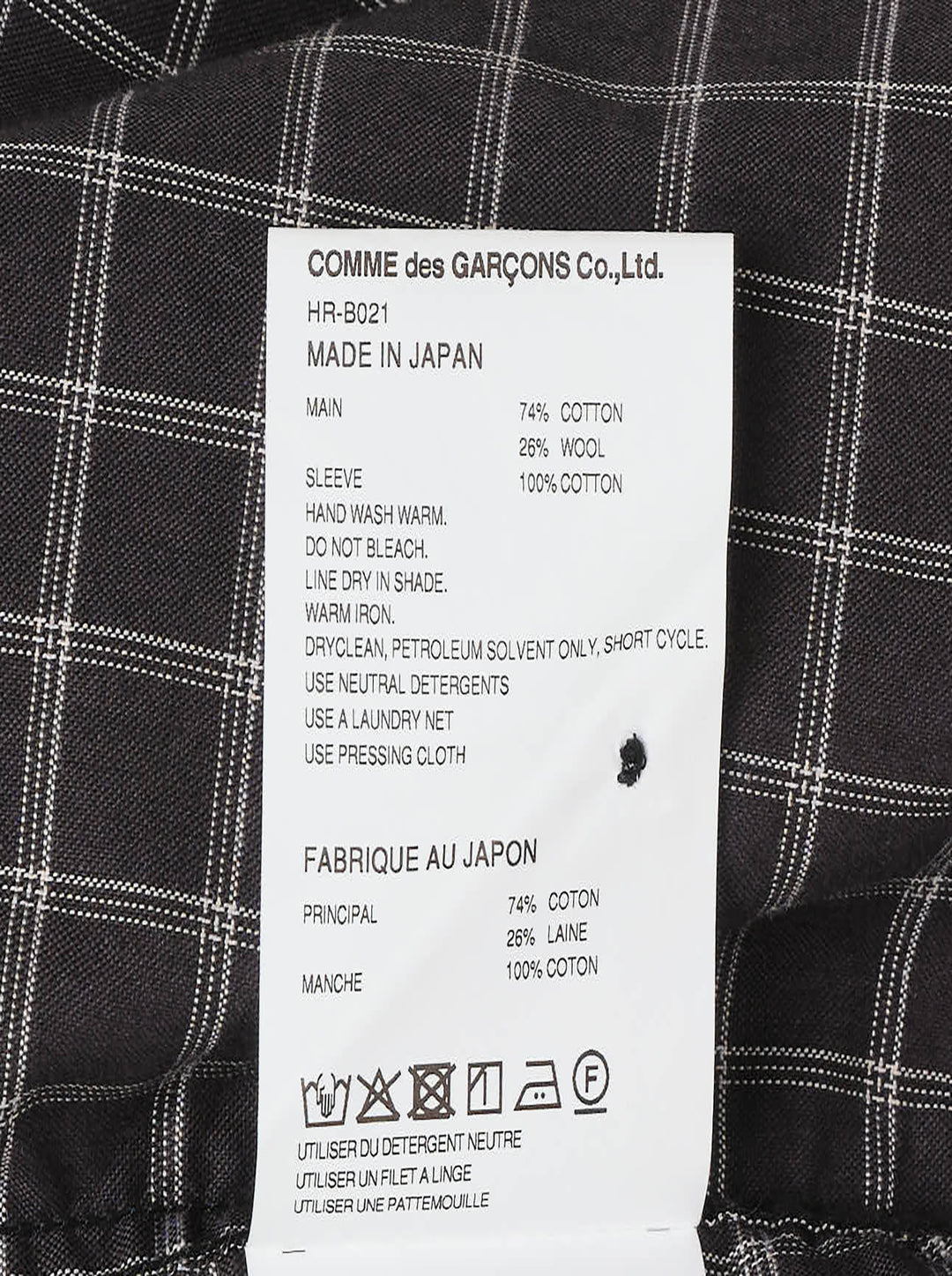 Comme des Garçons Homme long sleeve shirt with dark windowpane check cotton body and contrast solid black cotton broad cloth sleeves, shown flat on a white background - view 3