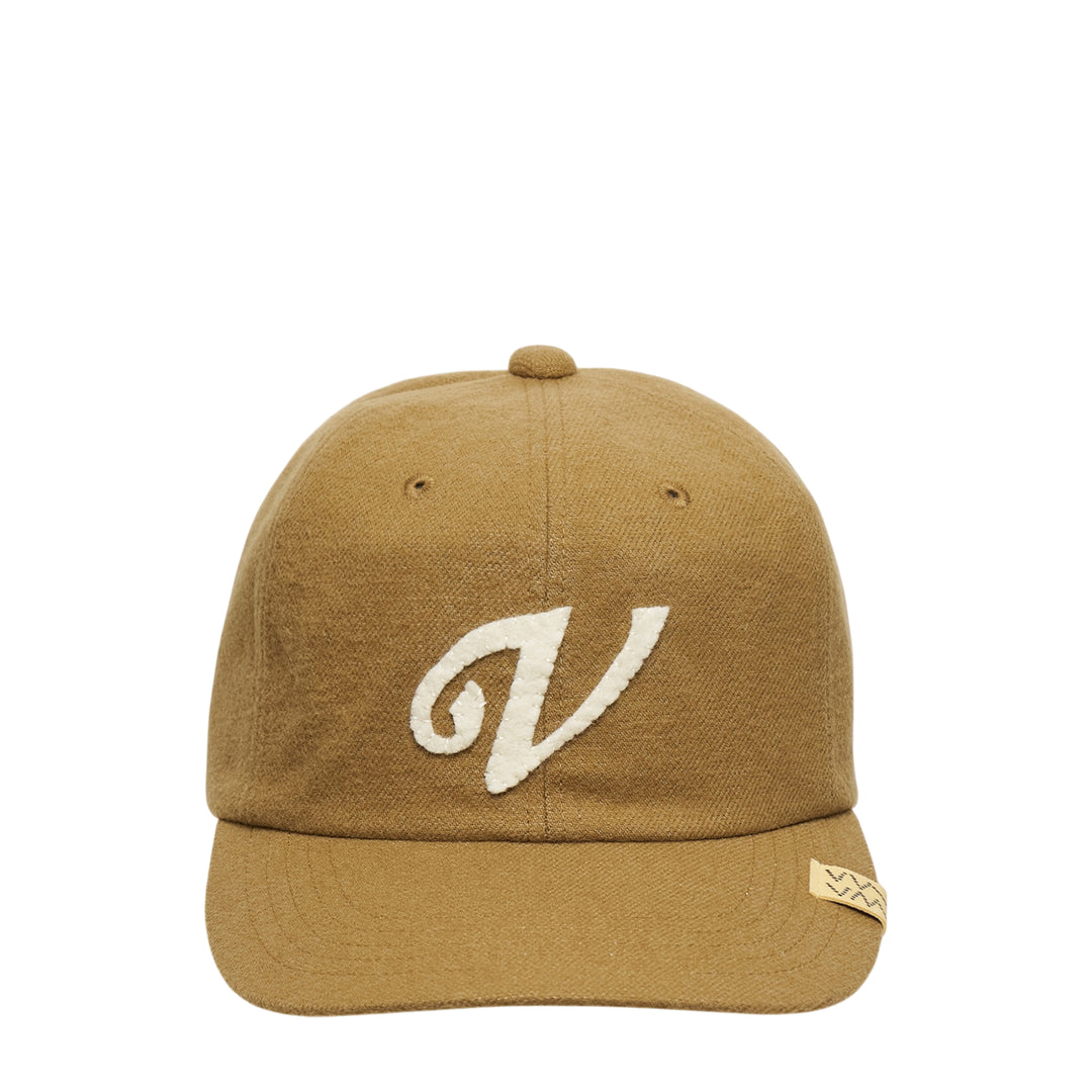visvim Fowler Cap in tan wool-linen blend with cream chenille script V appliqué on the front panel and woven branding label on the brim