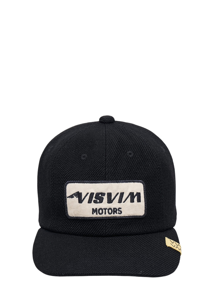 visvim Excelsior II black cap with cream embroidered Visvim Motors patch and yellow woven tag on the brim