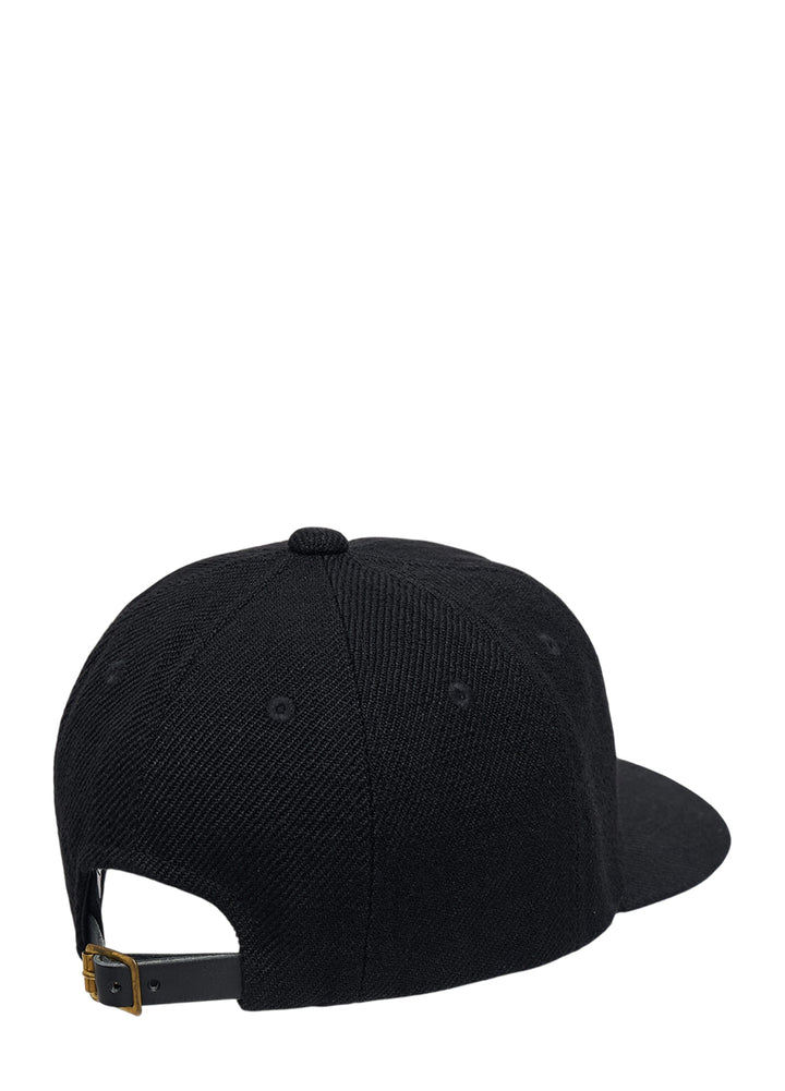 visvim Excelsior II black cap with cream embroidered Visvim Motors patch and yellow woven tag on the brim - view 2