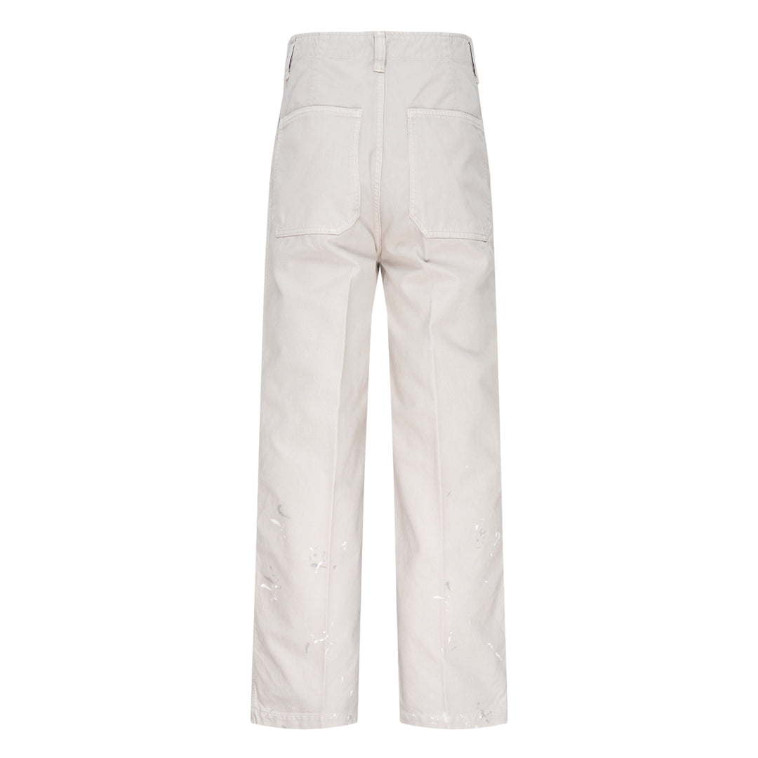 visvim Survey Damaged Pants in light stone, wide-leg silhouette with paint-splatter distressing on lower leg panels, front view on white background - view 2